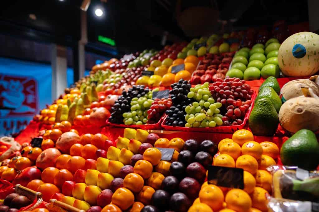 Colorful fruit berries are displayed in a market