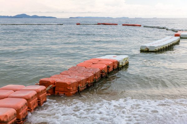 Polystyrene buoy on the sea surface. floating buoys and rope dividing area on the beach.