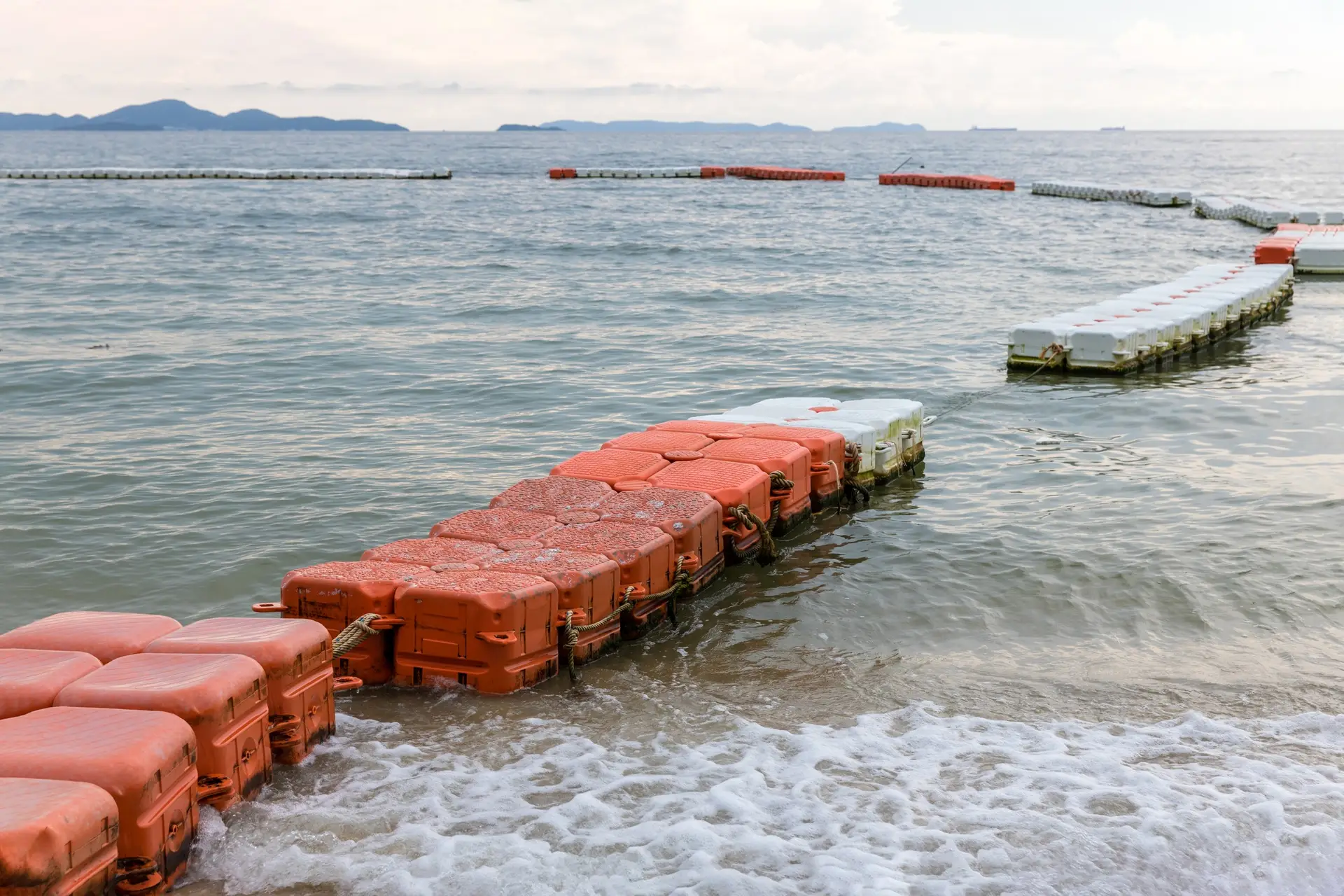 Polystyrene buoy on the sea surface. floating buoys and rope dividing area on the beach.